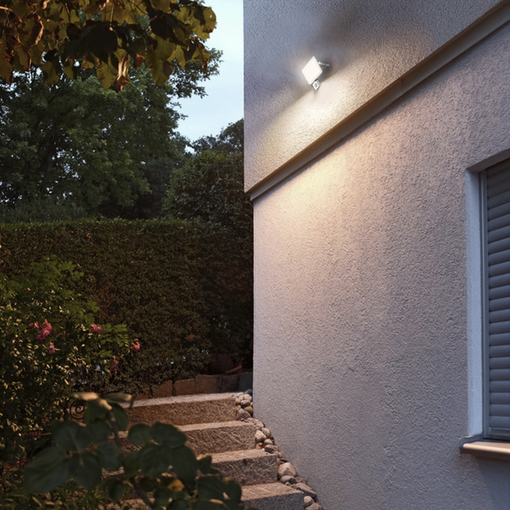 Floodlight with motion sensor on the building facade